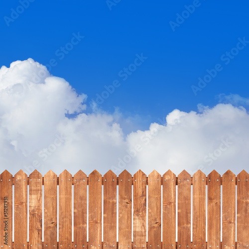 Wood picket fence with blue sky