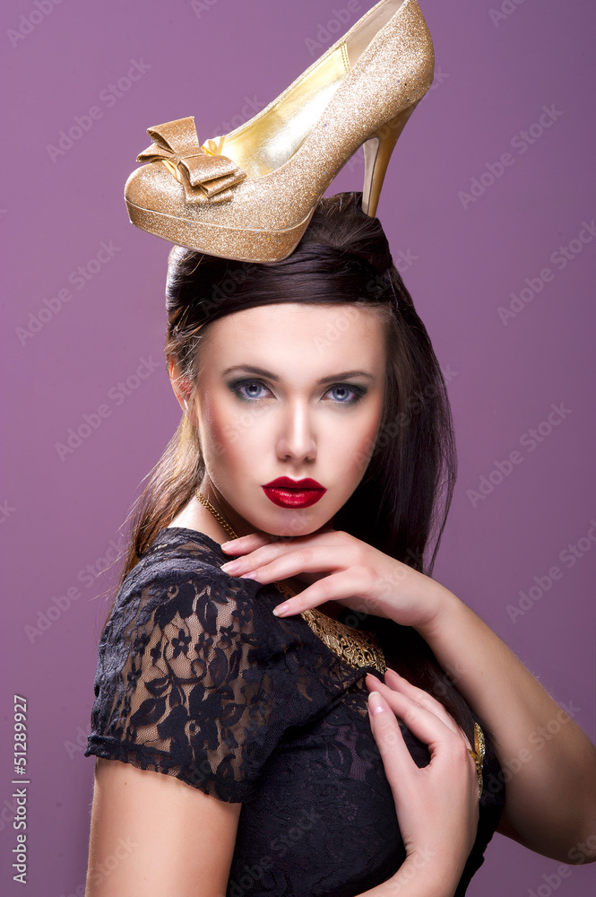 Fotka „Sexy woman with gold shoe on head“ ze služby Stock | Adobe Stock