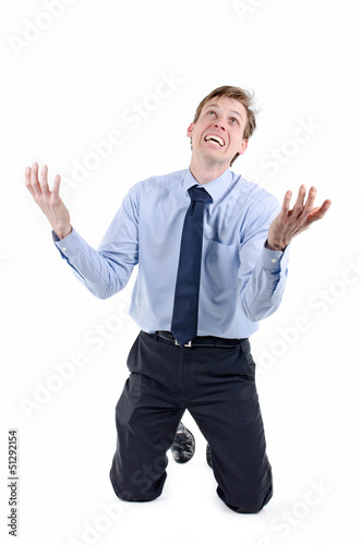 stressed businessman on knees praying for help