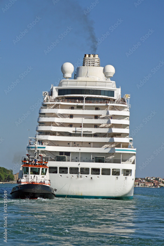Naklejka premium giant cruise ship for the transportation of passengers pulled by