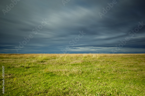 empty field and stormy sky