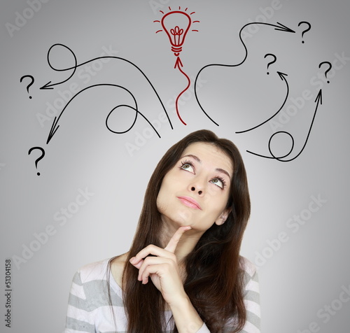 Thinking woman making decision and have an idea. She looking up photo