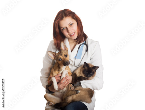 Canvas Print vet in medical uniform holding a cat and a dog on a white backgr