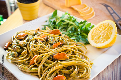 Spaghetti with mussels meat and pesto