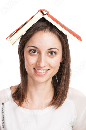 Beautiful young woman holding red book on her head