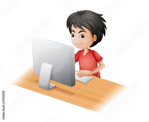A young boy using the computer