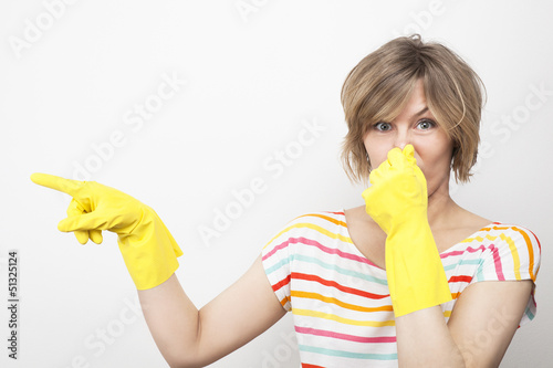 Schilderij op canvas Young beautiful woman in rubber gloves holding her nose