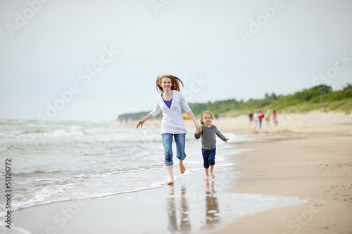Little girl and her mother on the beach