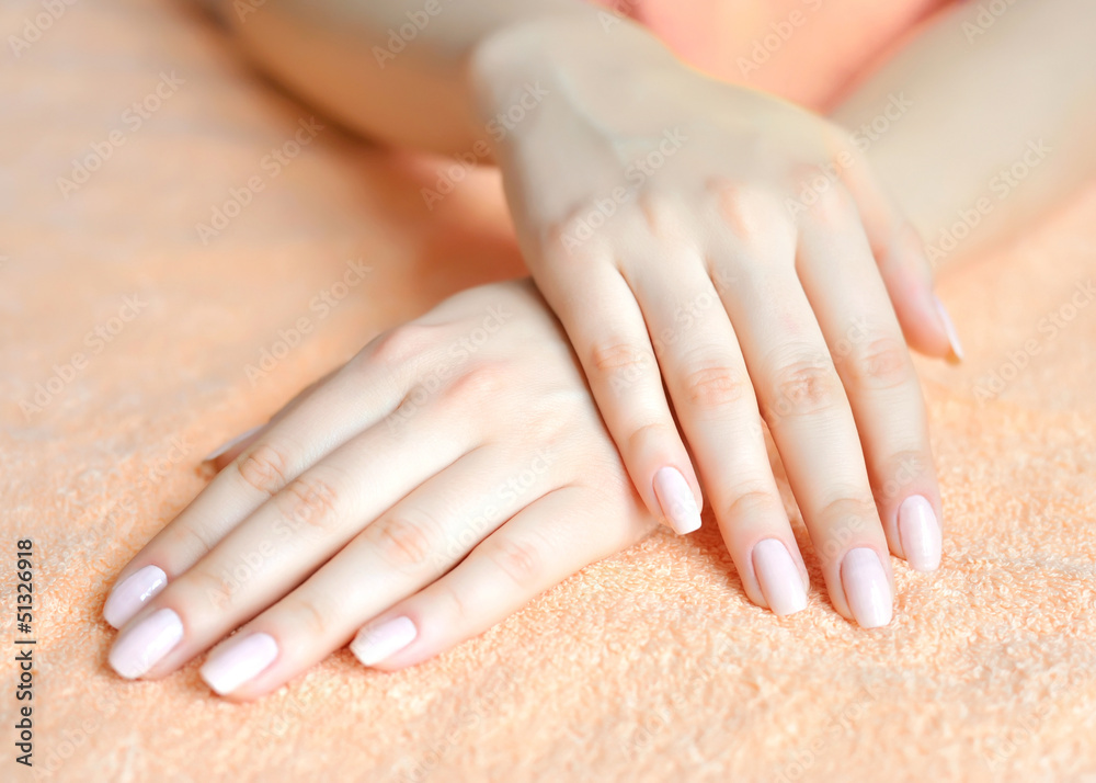 Beautiful woman hands are on a towel