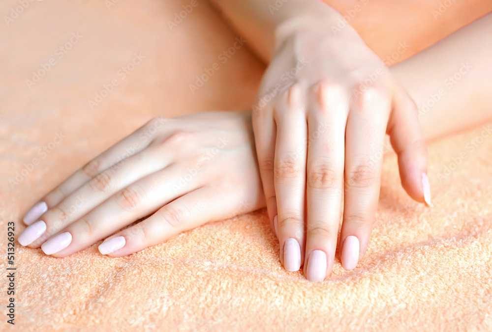 Fototapeta premium Beautiful woman hands are on a towel