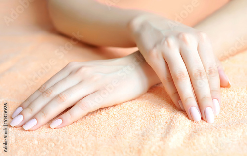 Beautiful woman hands are on a towel