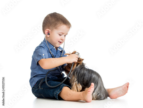 boy child examing dog puppy...
