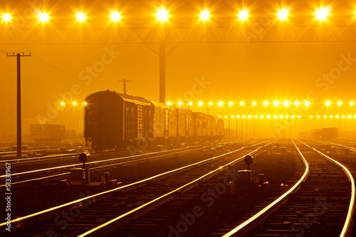 Cargo train platform at sunset with container