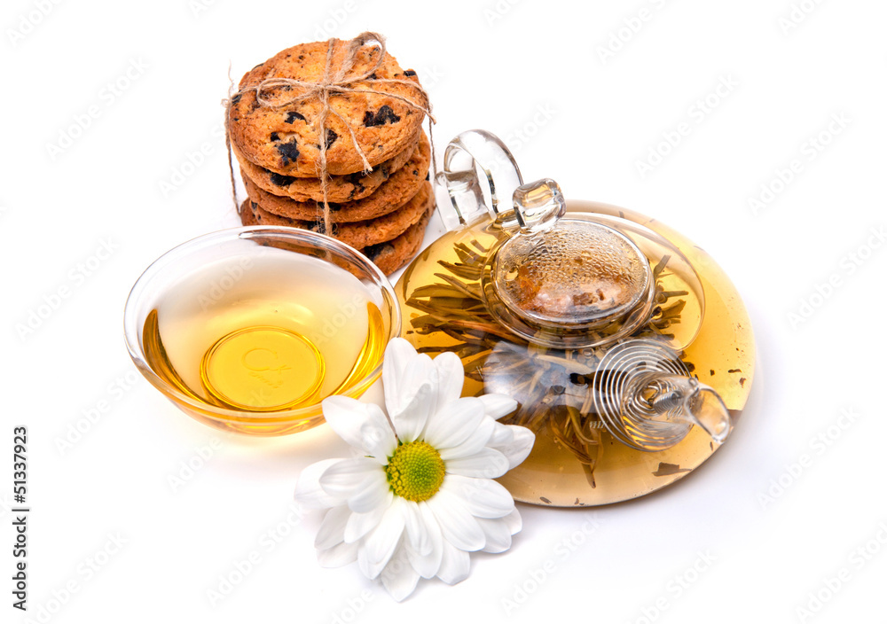 green tea with cookies and flowers on a white background green tea with cookies and flowers on a white background
