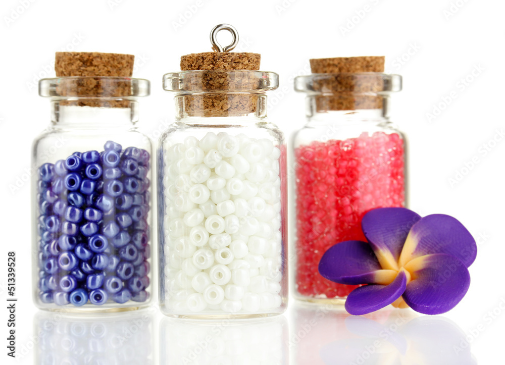 Little bottles full with colorful beads isolated on white Little bottles full with colorful beads isolated on white