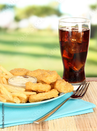 Fried chicken nuggets with french fries,cola and sauce