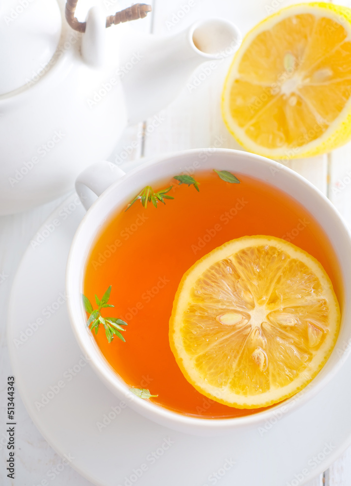 Fresh tea with lemon in the white cup Fresh tea with lemon in the white cup
