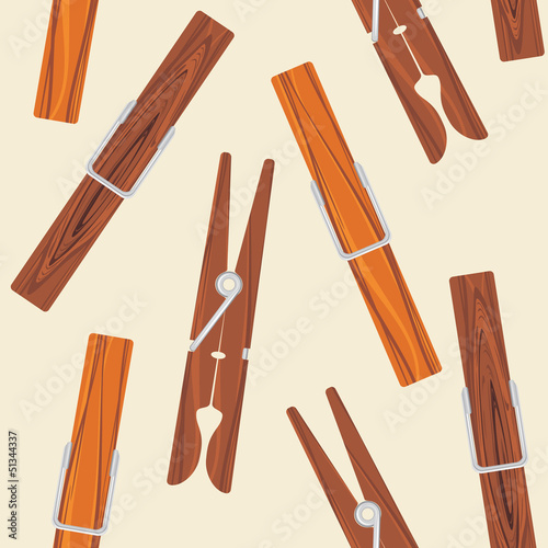 Wooden clothespins on the beige background
