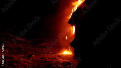 Lava flow at night in to the sea