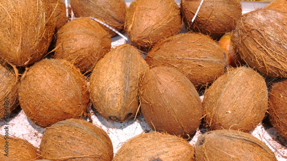 Ripe coconuts in market as background