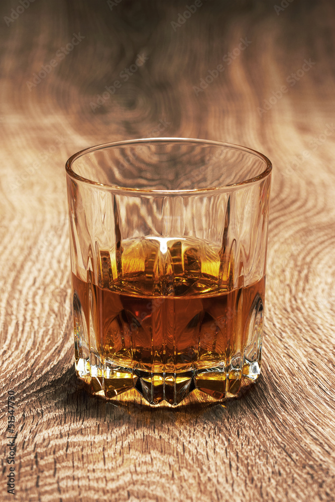 whiskey in glasses on wooden