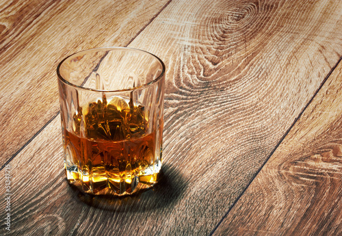 whiskey in glasses on wooden