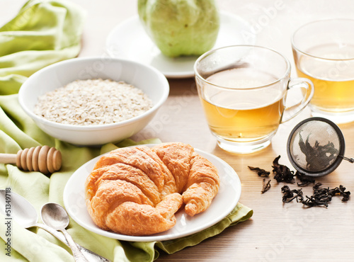 healthy breakfast: croissant, porridge and green tea
