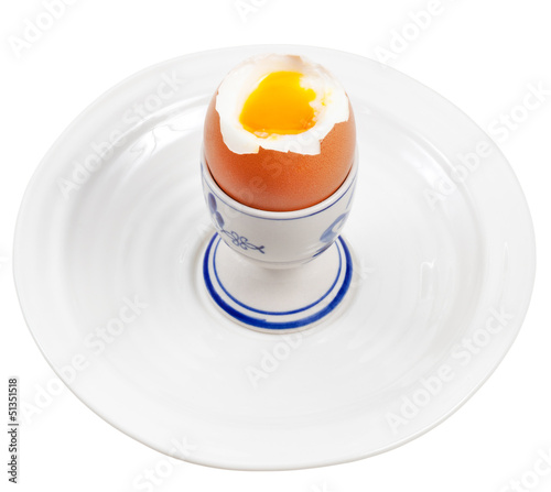 Light boiled egg in egg cup on white plate photo