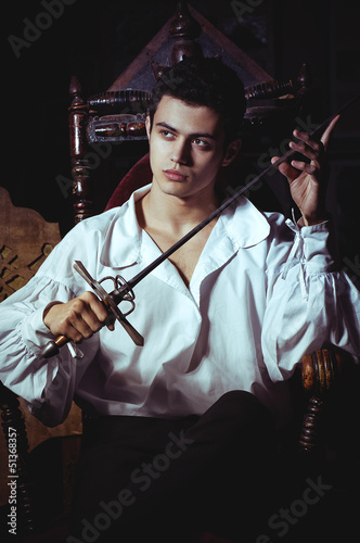 Portrait of a romantic man with a sword photo