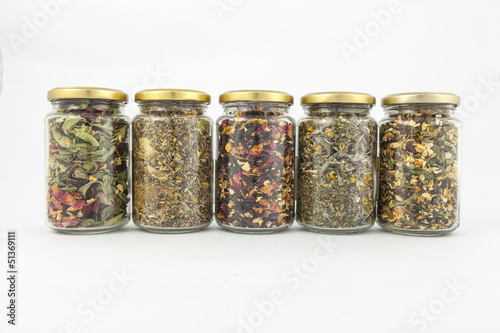 transparent glass jars of different herbs