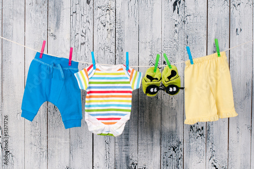 Baby clothes hanging on the clothesline. photo