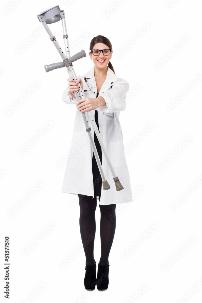 Smiling medical expert holding pair of crutches Smiling medical expert holding pair of crutches