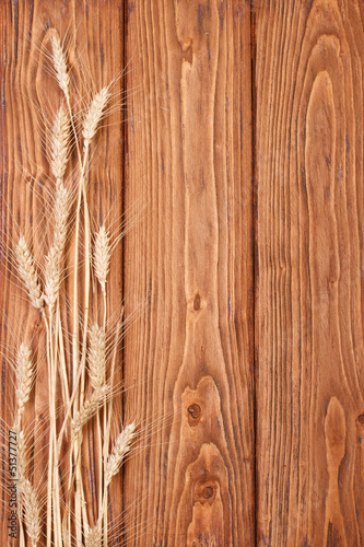 Ears of wheat on a wooden oak board