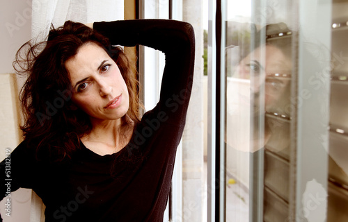 Portrait of beautiful woman near the window photo