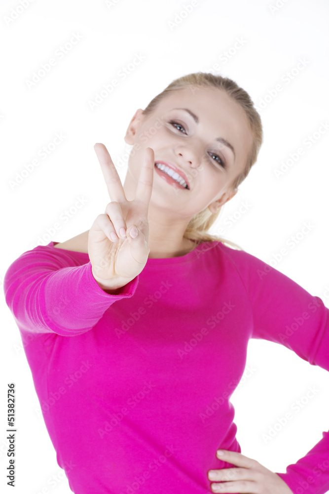 Happy young teenager girl showing victory sign Happy young teenager girl showing victory sign