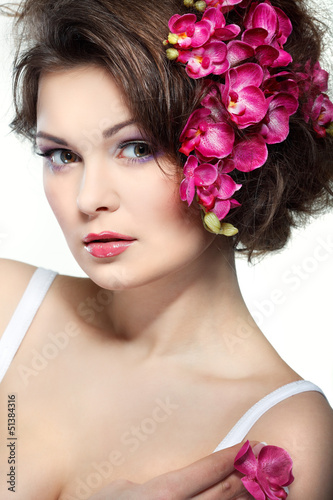  beautiful  brunette with pink orchids in hairs  cosmetics