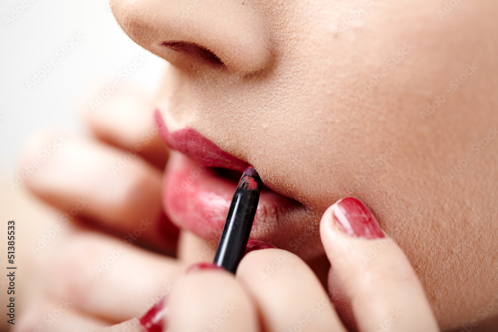 Woman having lipstick applied