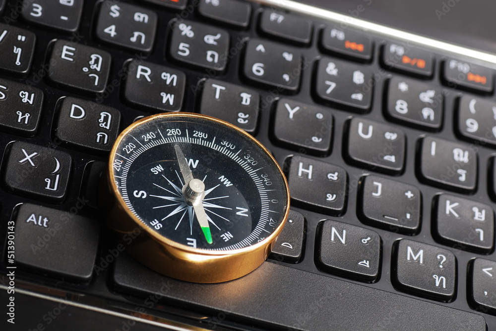 compass on computer keyboard, business decision compass on computer keyboard, business decision