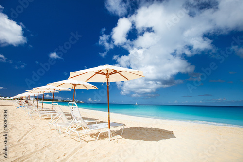 Chairs and umbrellas on tropical beach