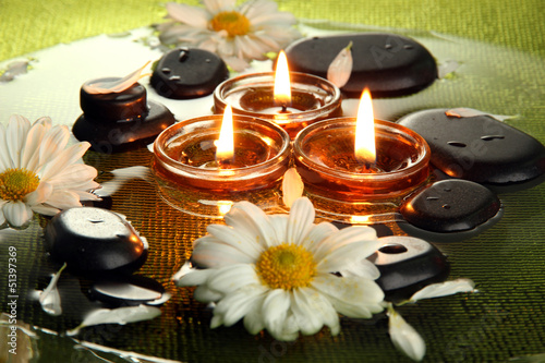 Fototapeta Naklejka Na Ścianę i Meble -  spa stones with flowers and candles in water on plate