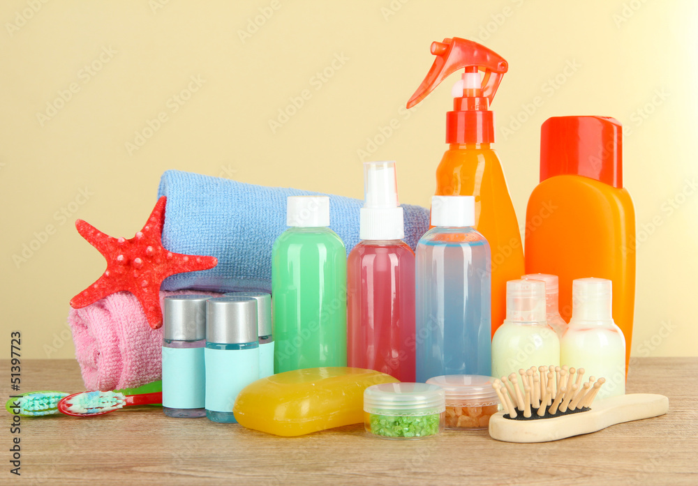 Hotel amenities kit on table on beige background Hotel amenities kit on table on beige background