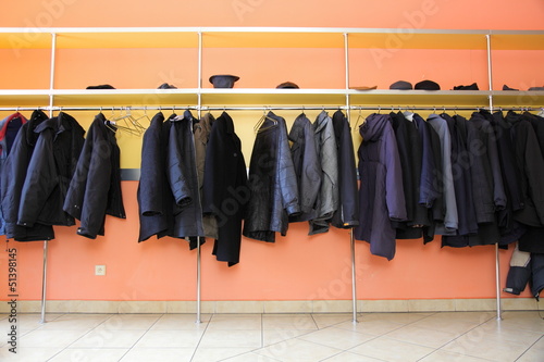 Many clothes in cloakroom photo