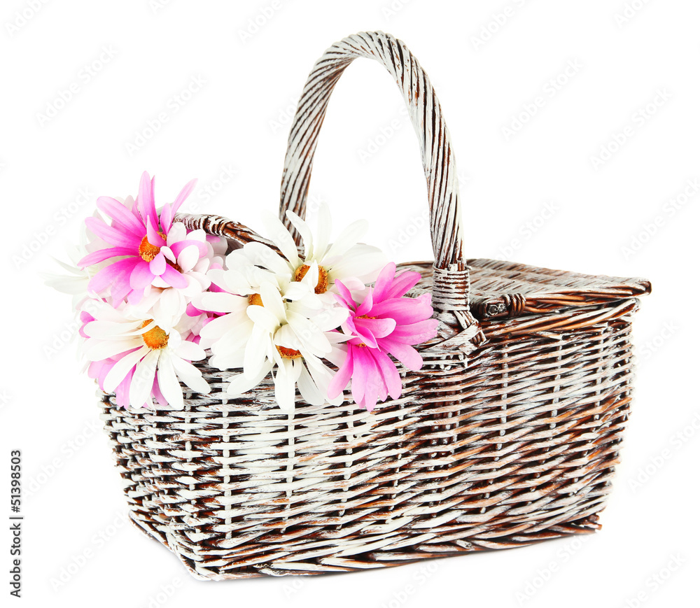 Picnic basket with flowers, isolated on white