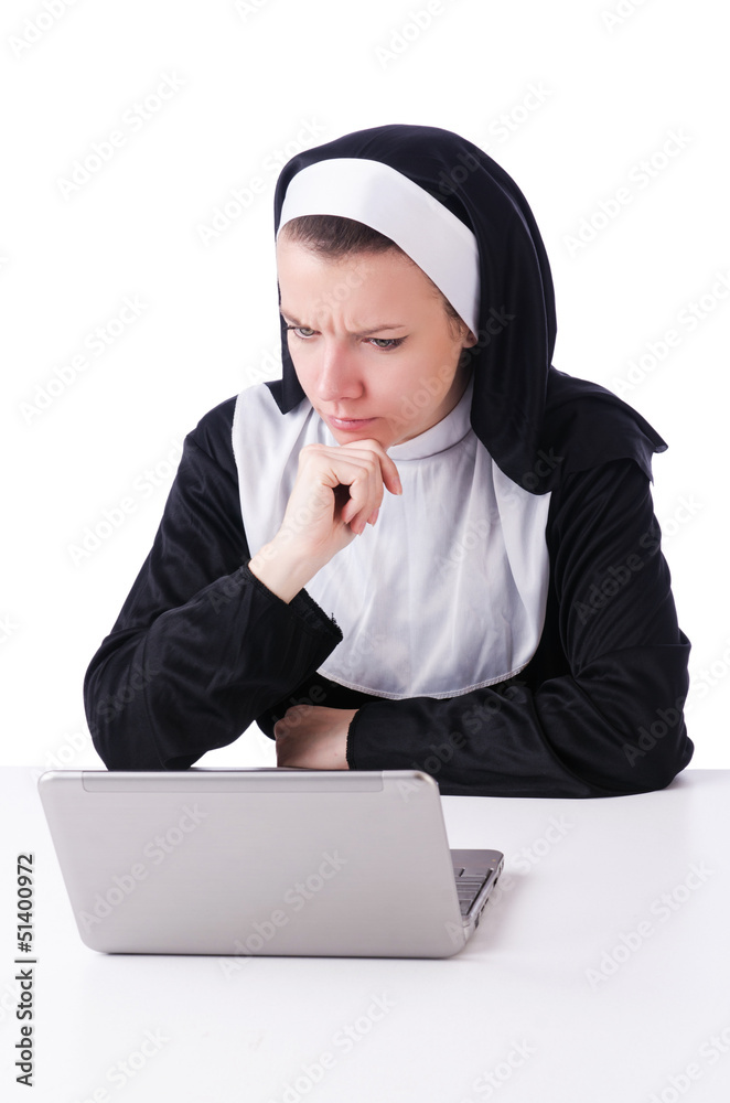 Nun working on laptop - religious concept