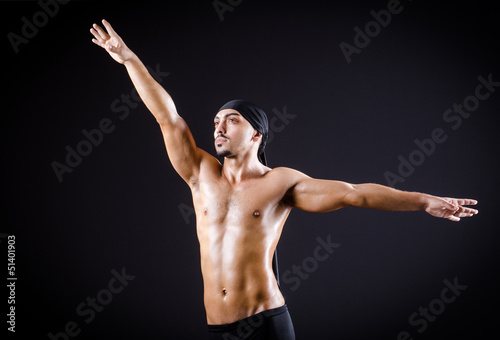 Dancer dancing in the dark studio