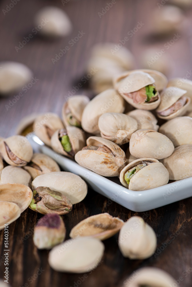 Pistachios on wooden background Pistachios on wooden background