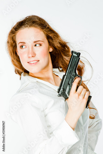 Young and beautiful woman with a gun