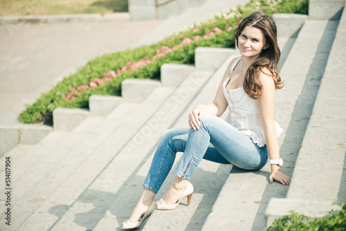 Portrait of a beautiful european woman sitting om steps