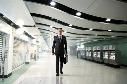 business man walking in subway