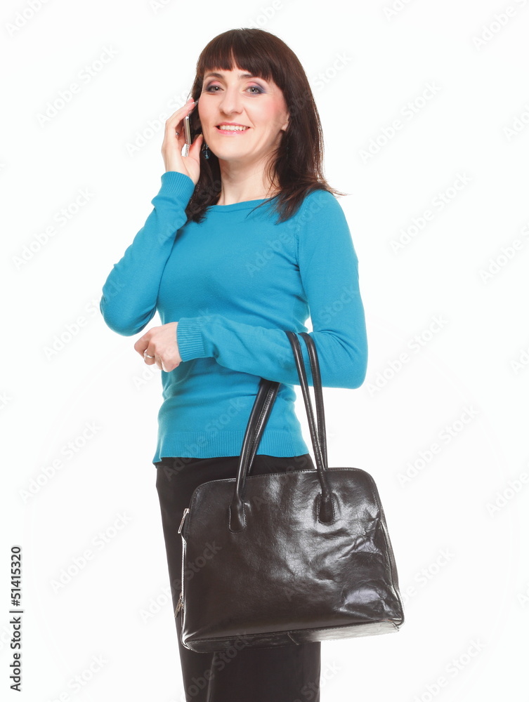 Woman talking on mobile phone and holding a bag Woman talking on mobile phone and holding a bag